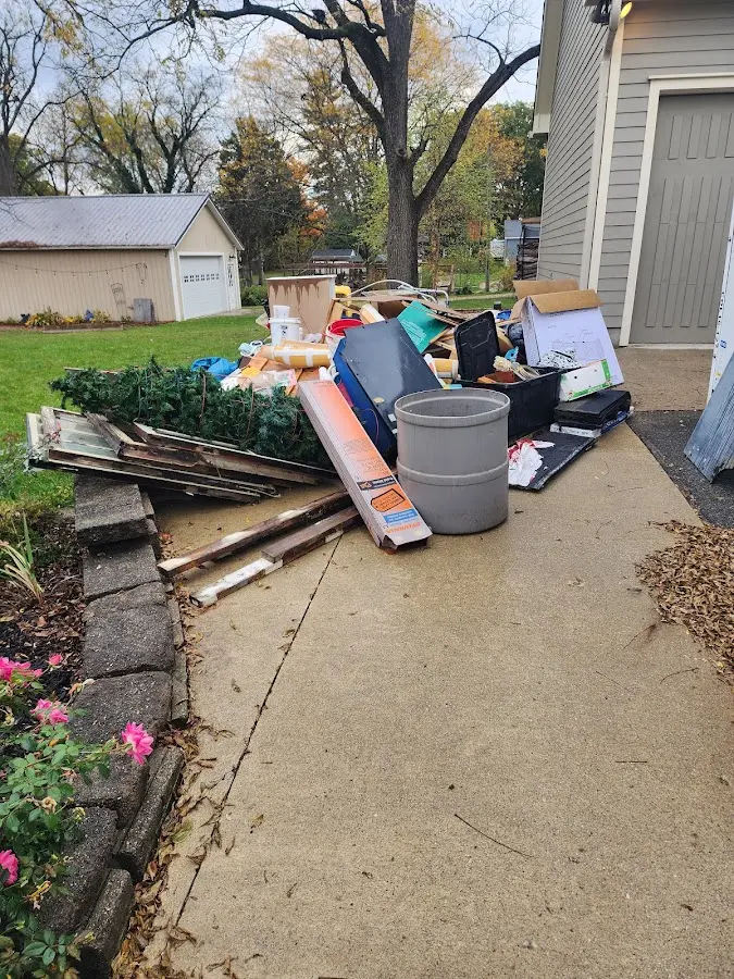 Dumpster being loaded with debris for Residential Dumpster Rental in Fox Point